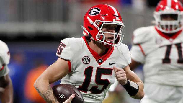 Georgia quarterback Carson Beck (15) runs the ball during the first half of the SEC Championship game against Alabama at Mercedes-Benz Stadium in Atlanta, on Saturday, Dec. 2, 2023